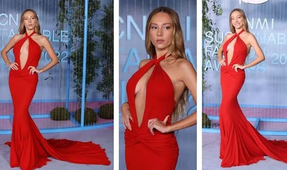 Ester Exposito stuns as she bares her fractionalization in a plunging red dress for Fashion Week